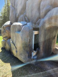 Concrete climbing rock with hidden fiberglass access door