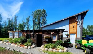 Concrete boulders in front of log building