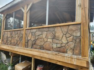 Carved stone base of deck enclosure