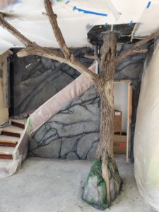 Hand carved tree and stone wall