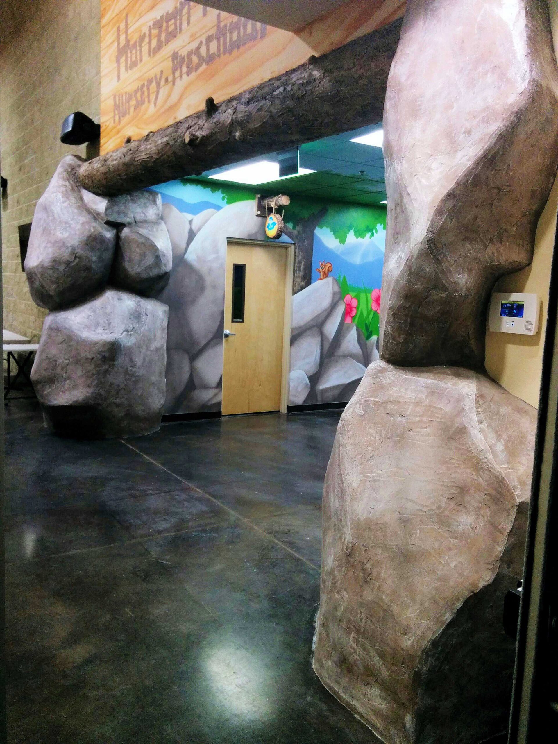 Concrete rocks and epoxy log in church foyer