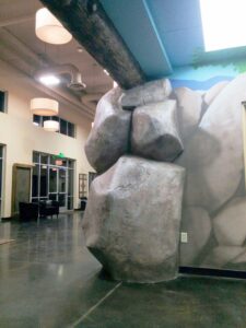 Concrete rocks and epoxy log in church foyer