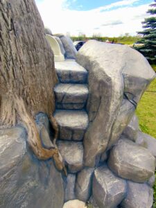 Concrete steps among stones and tree